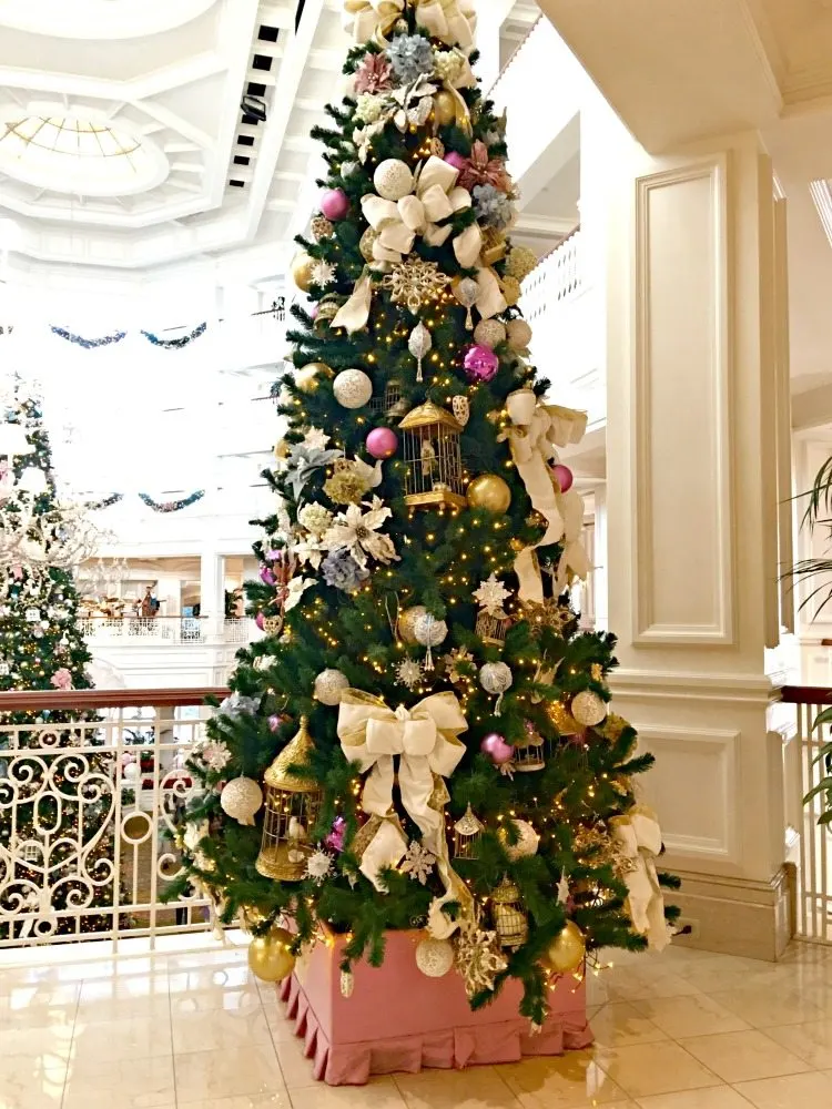 Christmas trees filled with victorian decorations of bows, bird cages, flowers and more.