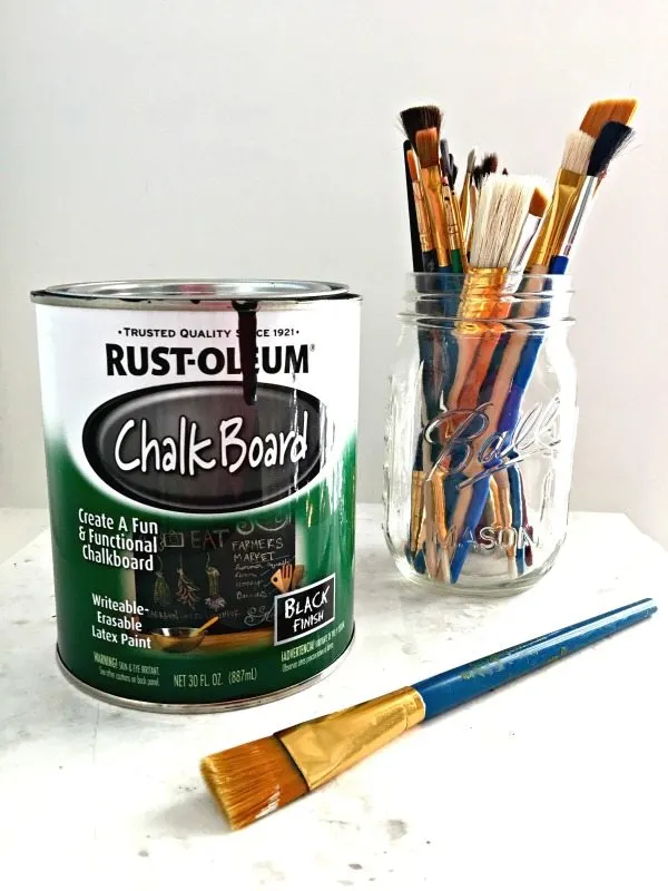 Chalkboard paint and artist paint brushes to make a chalkboard