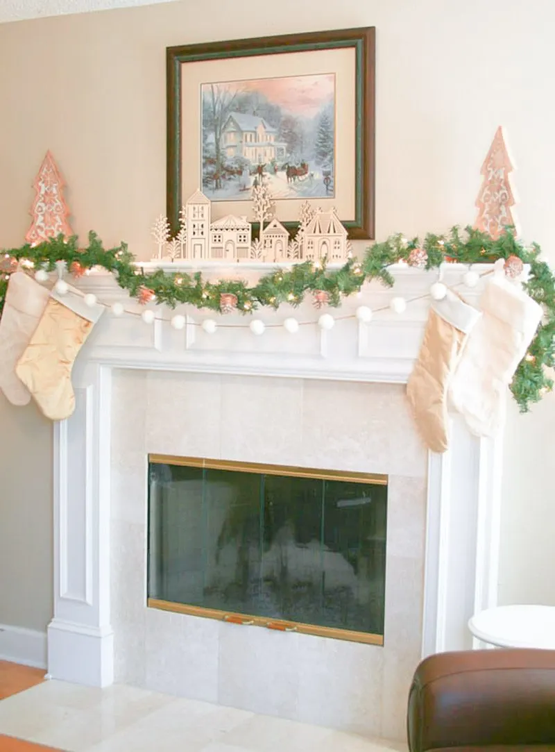 Christmas mantel decorated in white, gold and wood tones and McDonald's Christmas Home Tour