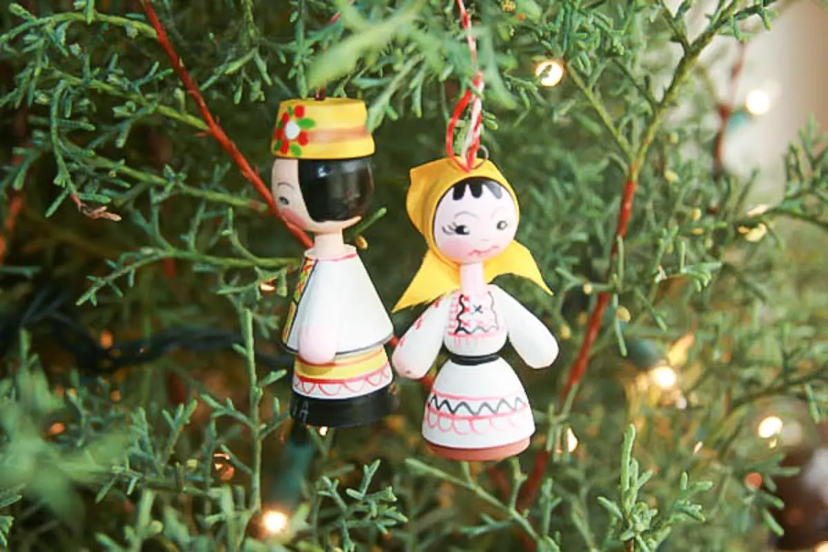 White rustic outdoor Christmas decorations of a girl and boy