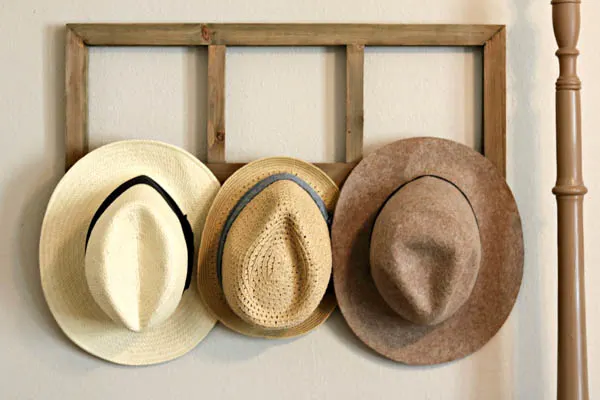 how to organize your home and stay organized by hanging hats on hooks
