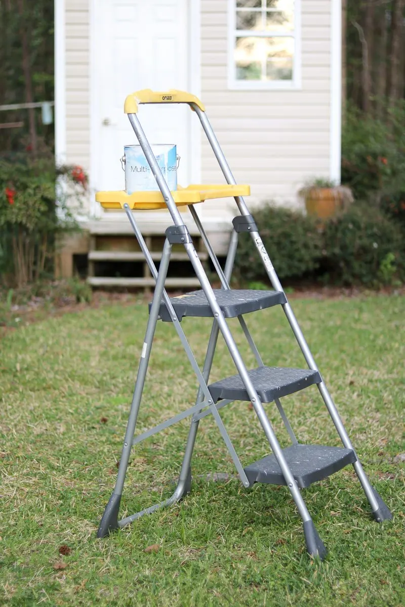 best painting tools is a platform ladder shown here holding a can of Sherwin Williams paint.