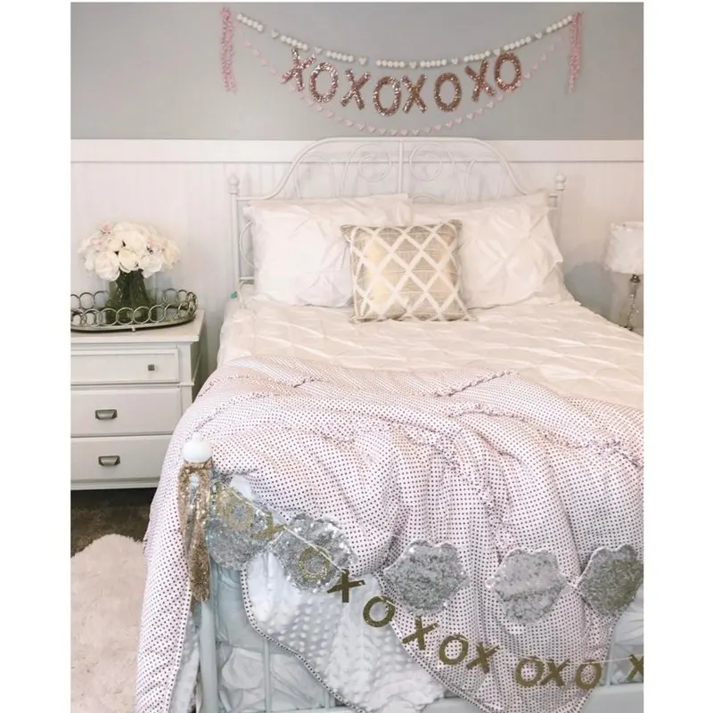 Valentine's Banners of XO garland over bed by Pearl & Jane