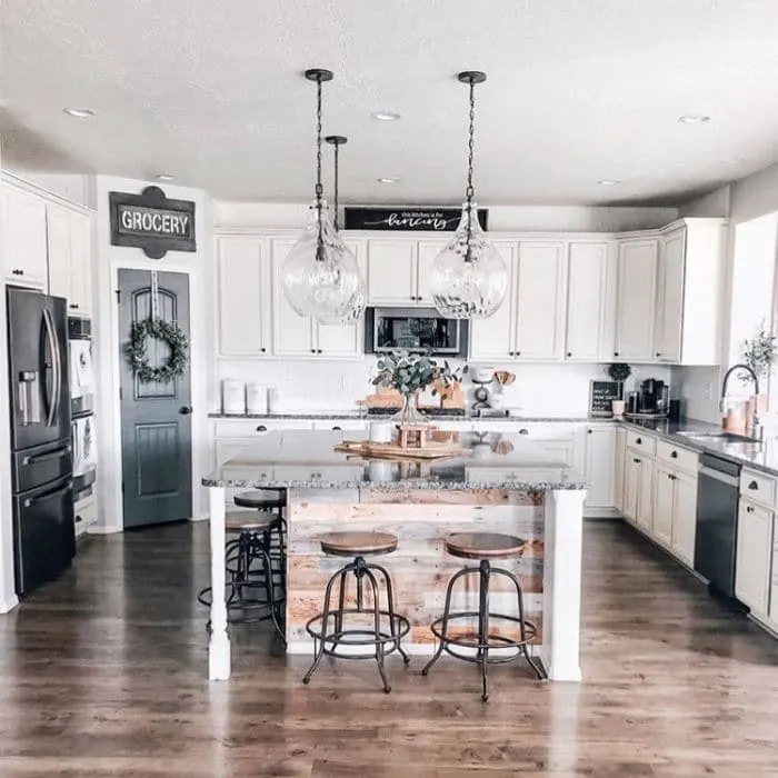Beautiful Farmhouse Kitchen by Grey Birch Designs with a kitchen complete with a pantry, white cabinets, granite countertops and shiplap on the kitchen island