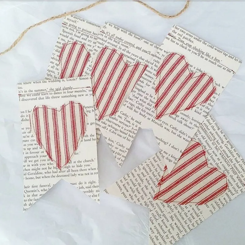 Valentine's Banners of book pages with red and white ticking fabric hearts sewn to paper from Orchard Slope