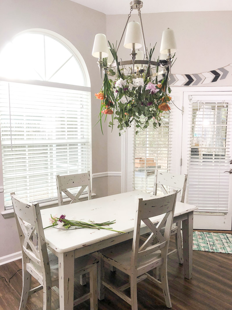 Hang flowers upside down on a chandelier for a hanging flower meadow in your dining room