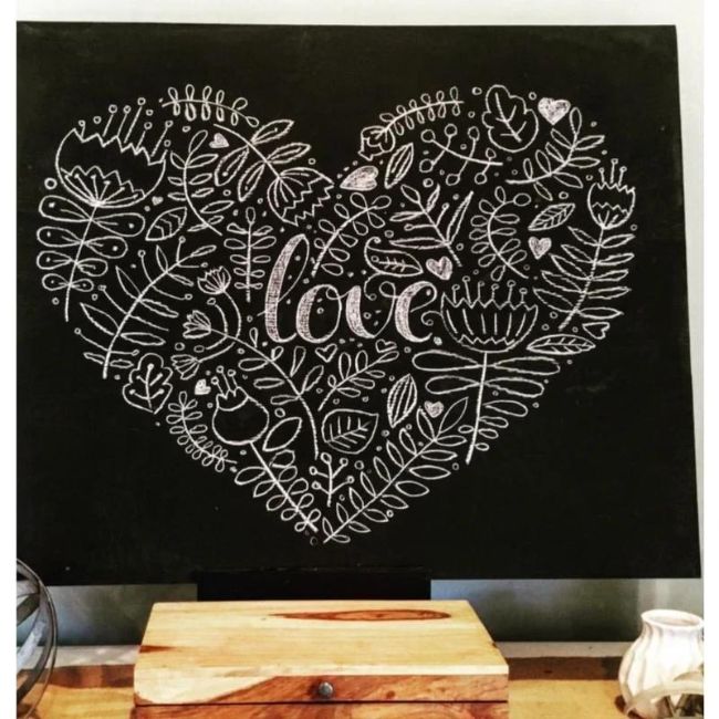 Chalkboard idea for February. Floral heart with love written on it drawn on a chalkboard
