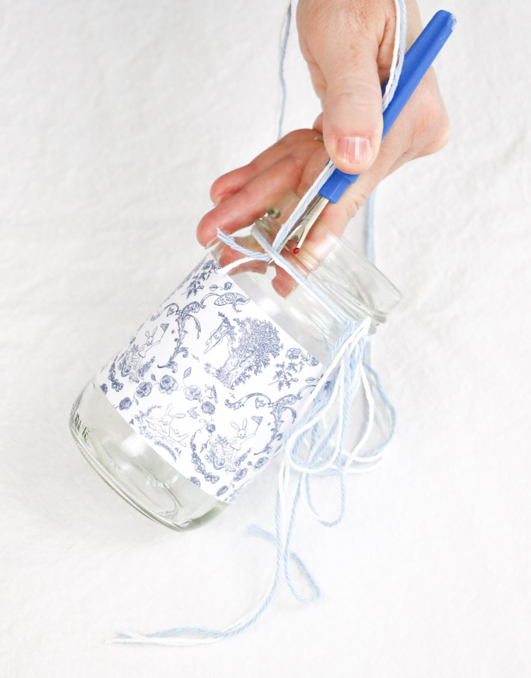 May day basket with a glass jar wrapped in a toile free printable and white twine and blue yarn 