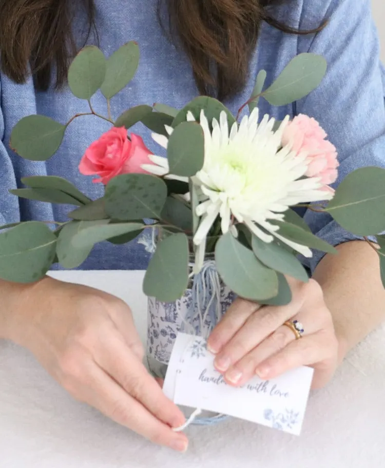 Arranging flowers in a May Day Mother's day toile wrapped upcycled salsa jar and adding a free printable gift tag.