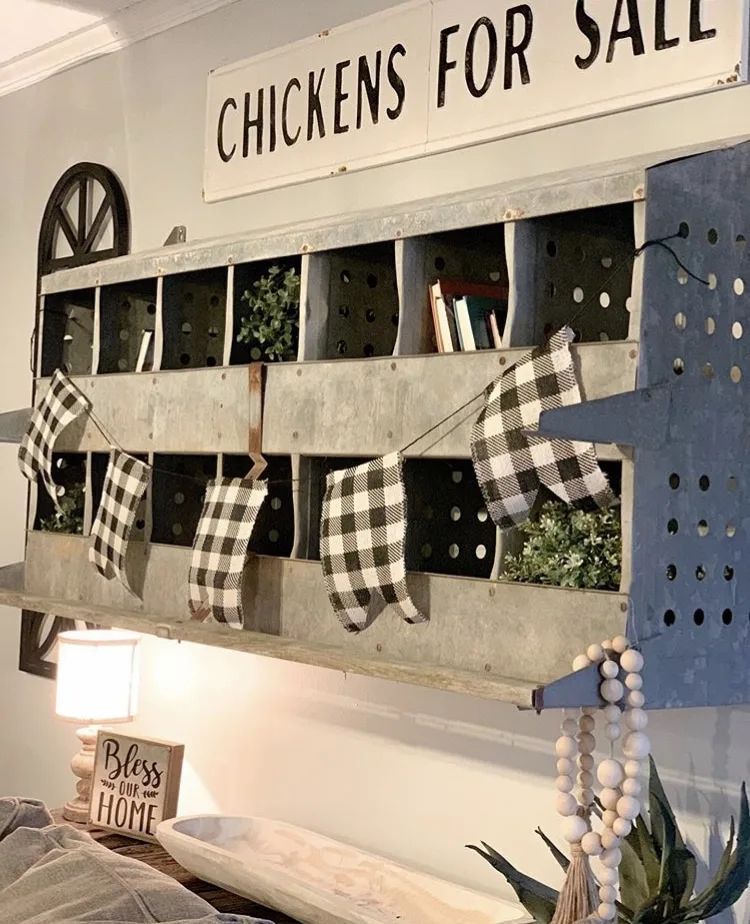 Chicken Nesting Box by Fixing Up Our Forever with a nesting box over a sofa with a buffalo check banner, wooden beads and a chickens for sale sign over top