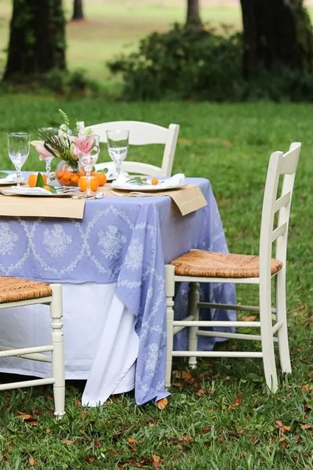 Beautiful white and rush seat chairs for an outdoor mother's day table setting