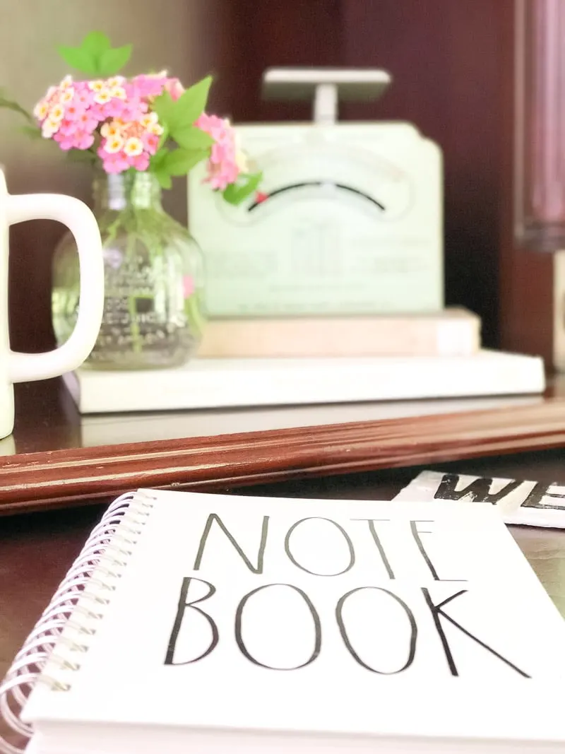 decorating with vintage scales in an office with flowers and rae dunn notebook