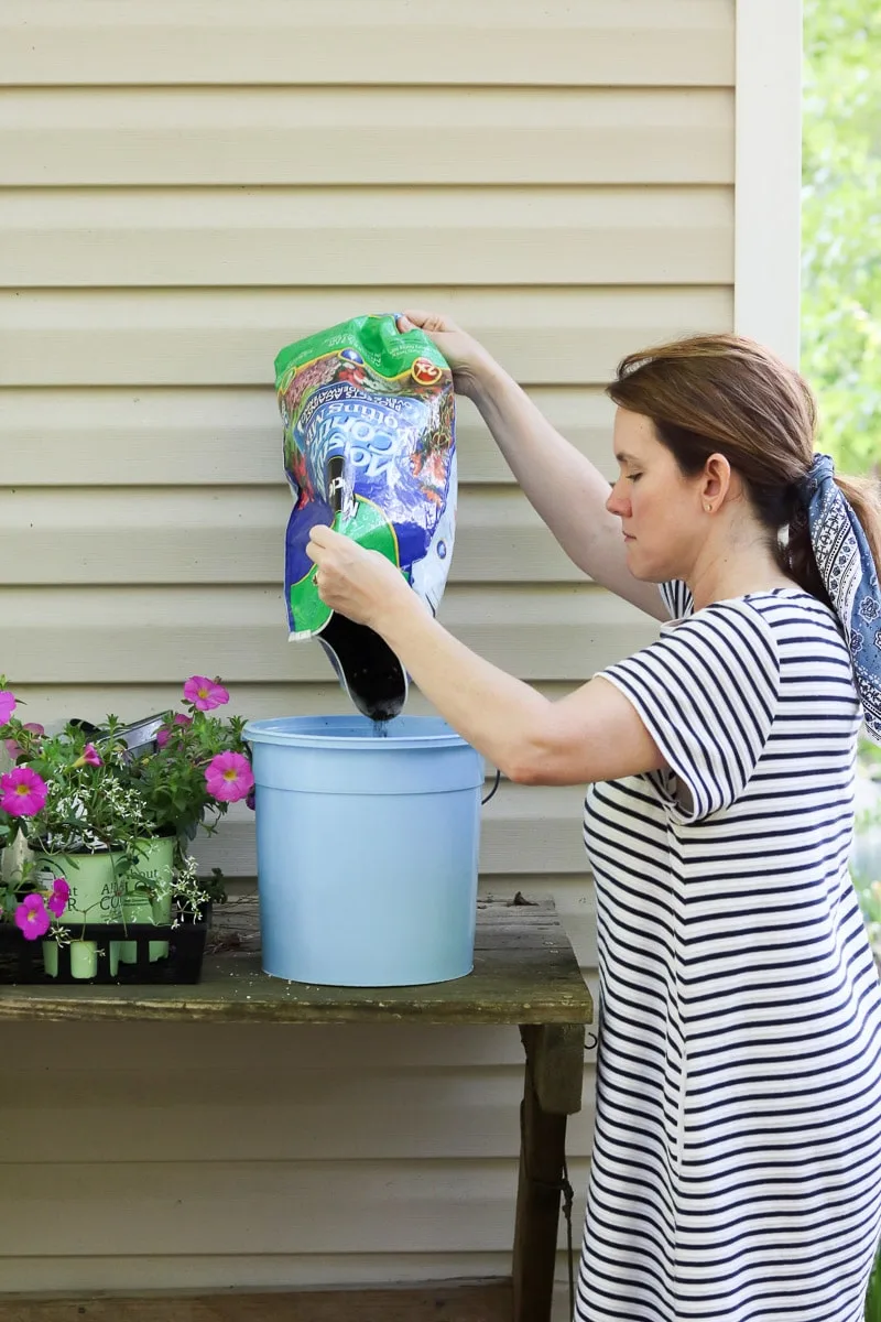 Container flower gardening adding soil to the pot