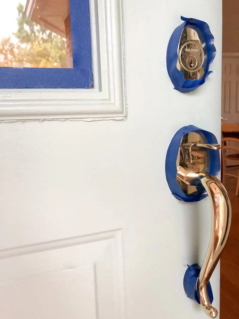 How to paint a front door without removing it.  Showing taping off things like the door knobs, locks and windows so paint will stay on the door and not go onto areas it should not.