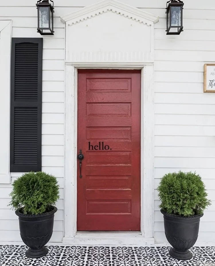 Modern Front Doors by The Morris Manor with a red door on a white house with red vinyl letters that read "hello."