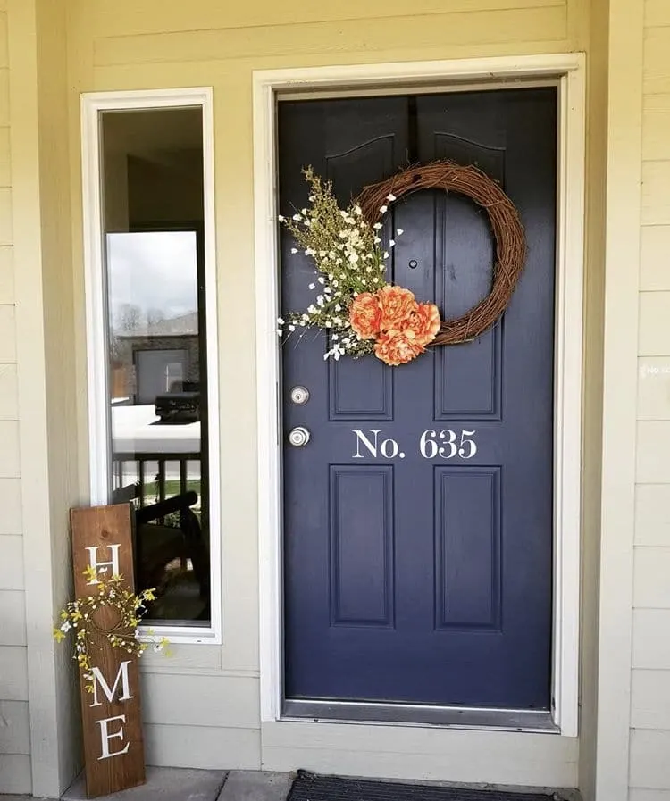 Modern Front Doors by Queen Wood Designs with a navy blue front door with a grapevine wreath and  white vinyl address numbers and a wooden home sign