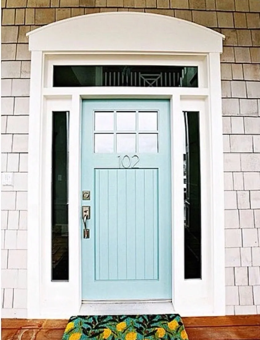 Modern Front Doors by HI Ya Papaya Mom with a light blue door with silver thin metal house numbers and a lemon welcome mat