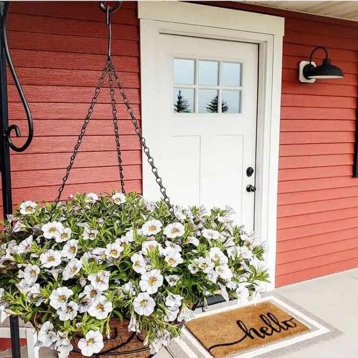 Modern Front Doors by Michaels Mini Farmette with a white door on a red house a white flower hanging planter and a hello welcome mat