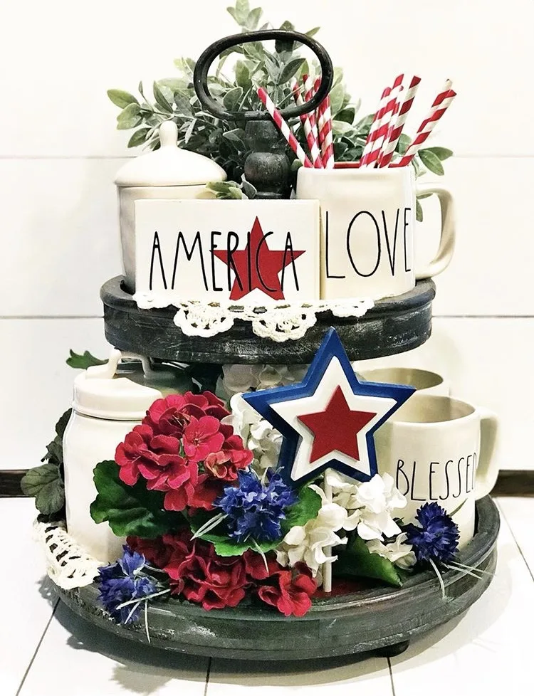 Patriotic farmhouse tiered tray ideas using Rae Dunn, plants and signs