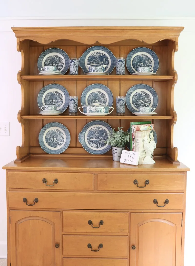 Currier & Ives ironstone dishes on a farmhouse hutch