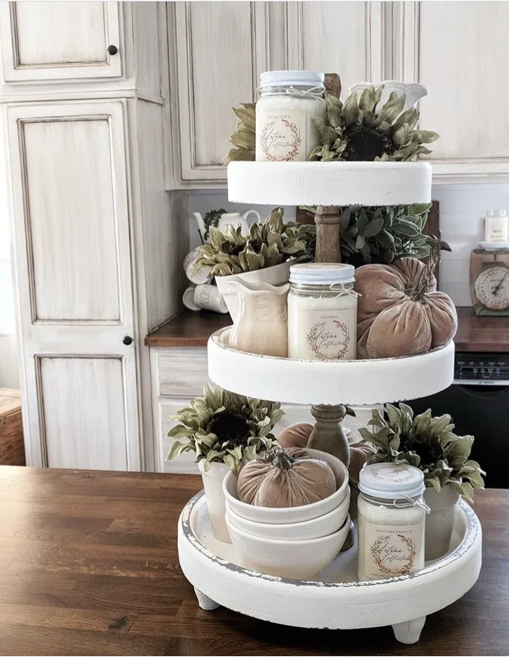 Fall Decor white cottage feel tiered tray by Down Shiloh Road. Her lovely tray is filled with jar candles, loads of green sunflowers, velvet pumpkins and white dishes.