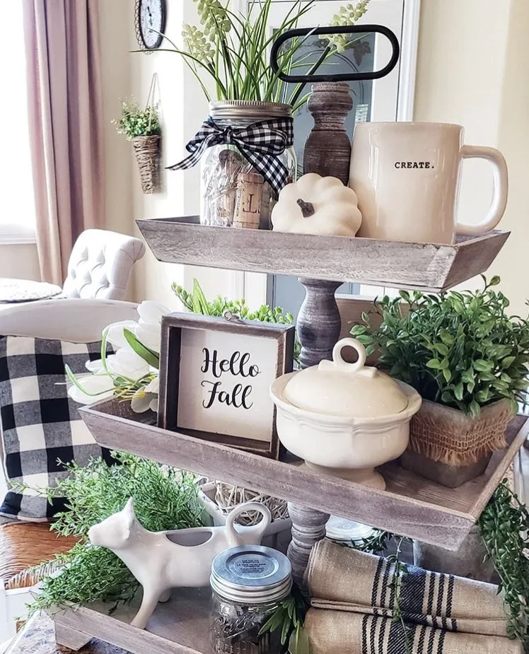 Fall Decor rectangle distress wood tiered tray by Blessed at Home. So many wonder ides on these trays. Each layer holds plants, Rae Dunn coffee mug, white pumpkin, Hello Fall sign, vintage dish towels, mason jars filled with corks and a sweet cow creamer.