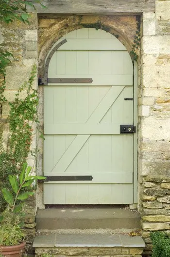 Country door in paint color Benjamin Moore Guilford Green used on a country style arched door