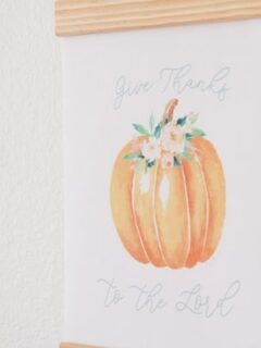 Fall Free Printable of a pumpkin with flowers and bible scripture from Psalms 107:1 Give Thanks to the Lord