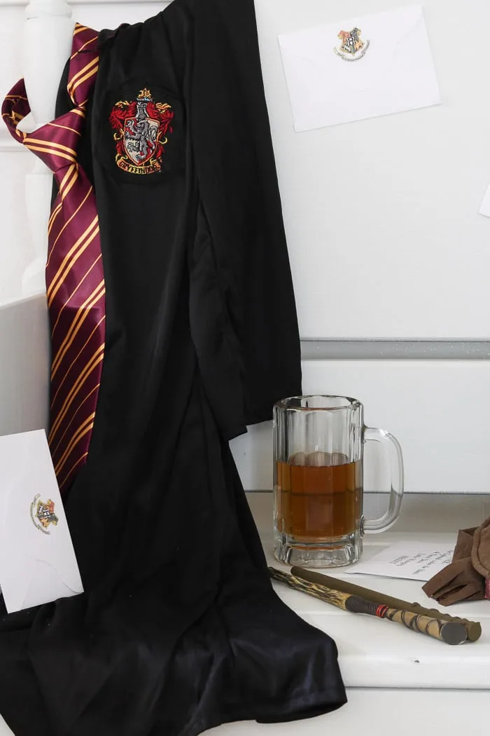 Halloween Decorations for a Harry Potter Celebration. Hogwarts uniform rob and tie. Butterbeer and wand.
