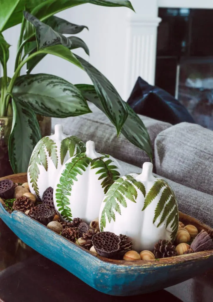 Decorating with dough bowls by Deeply Southern Home. This hand painted down bowl is filled with white painted pumpkins and fern leaves