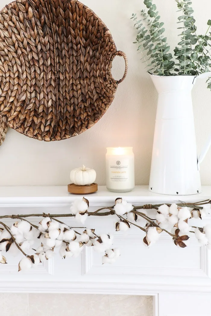 How to hang baskets on a wall for a DIY fall decor mantel design using candles and pumpkins