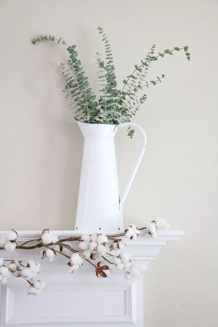 DIY fall decor mantel with a vintage french pitcher and eucalyptus