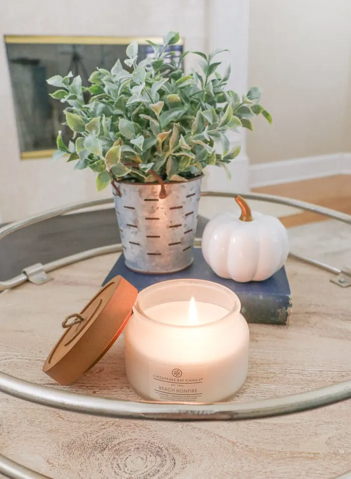 DIY fall decor idea using candles, plant, book and pumpkin on farmhouse tray