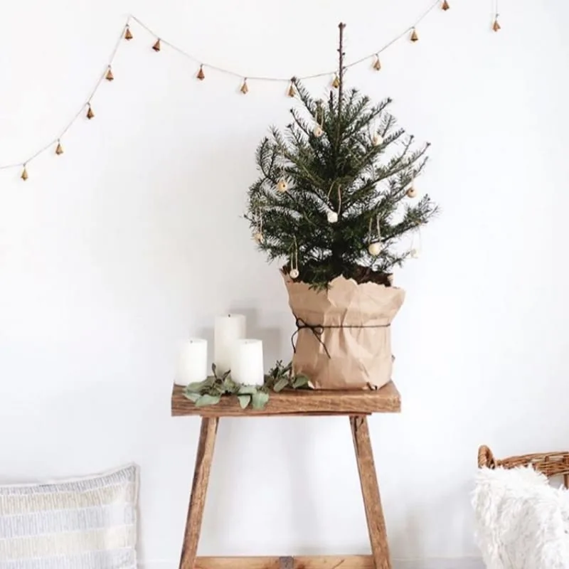 Minimalist Christmas Decorations by The Merry Thought tiny Christmas tree on stool with candles