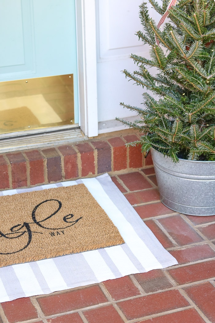 DIY rug using a drop cloth and chalk paint and layering door mat on top