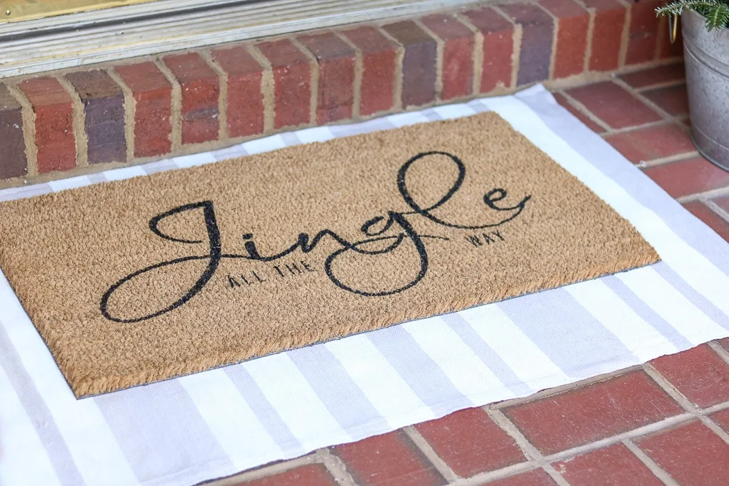 DIY rug using a drop cloth and chalk paint and layering a door mat ontop
