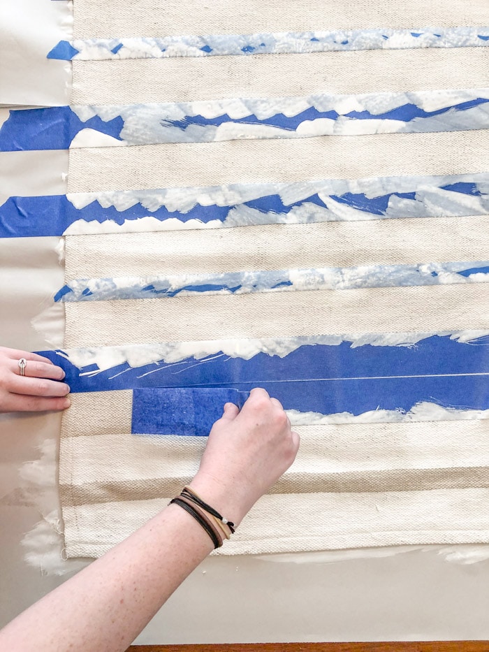 DIY rug using a drop cloth and chalk paint and painters tape