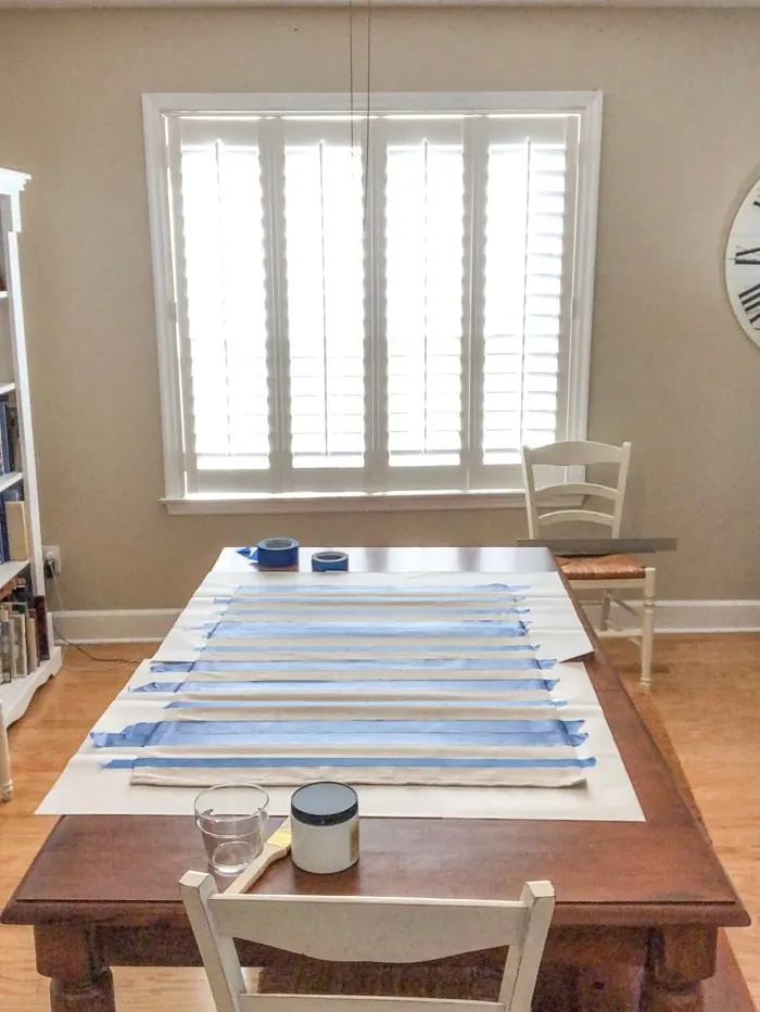 DIY rug using a drop cloth and chalk paint and painters tape
