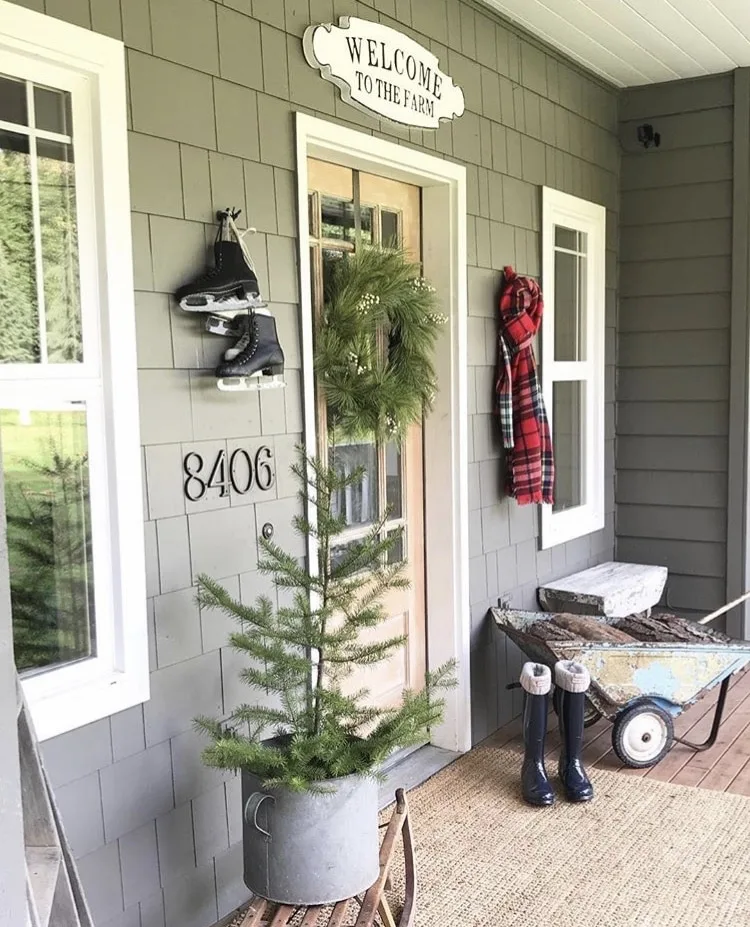 Christmas decorating ideas for porches by Little Farmstead mini tree in metal bucket with ice skates and scarf