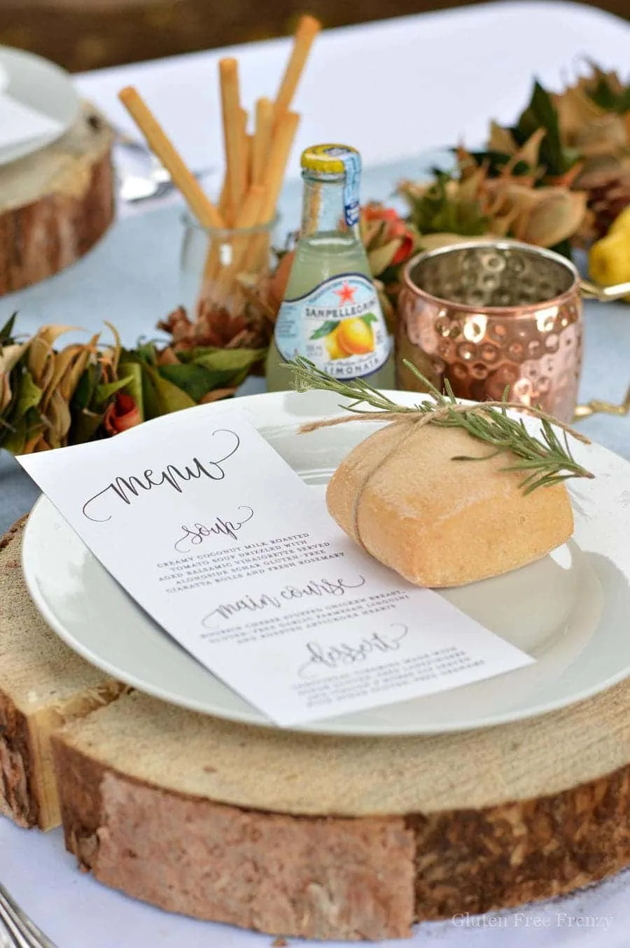 Italian Themed Dinner Party by This Vivacious Life with wood circle chargers and rosemary with a roll