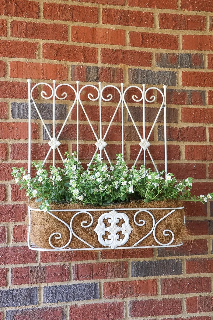 spring farmhouse porch decorating ideas with iron wall flower box