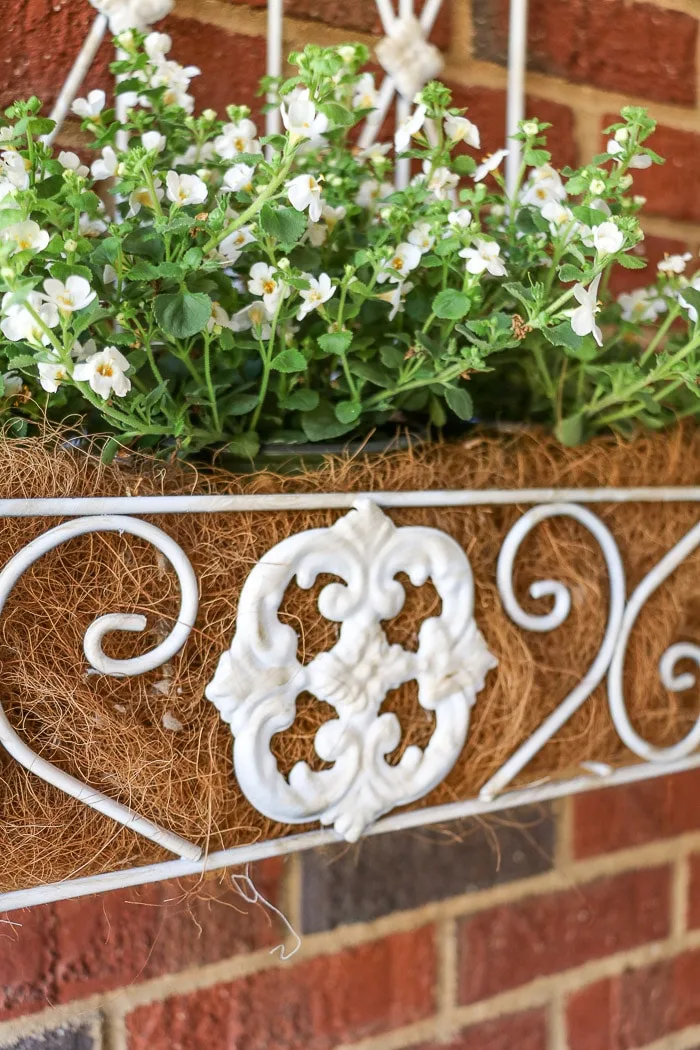 spring porch decorating ideas with iron wall flower box