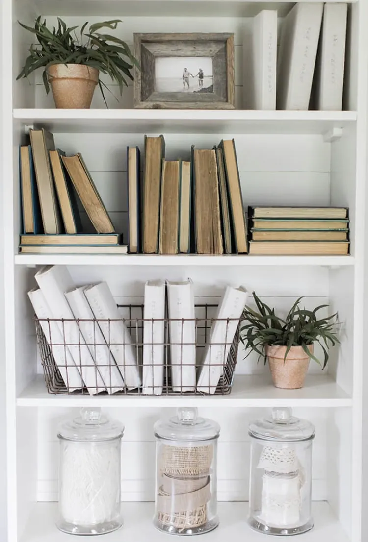 DIY Bookshelf Makeover by Love Grows Wild with vintage books and vintage lace