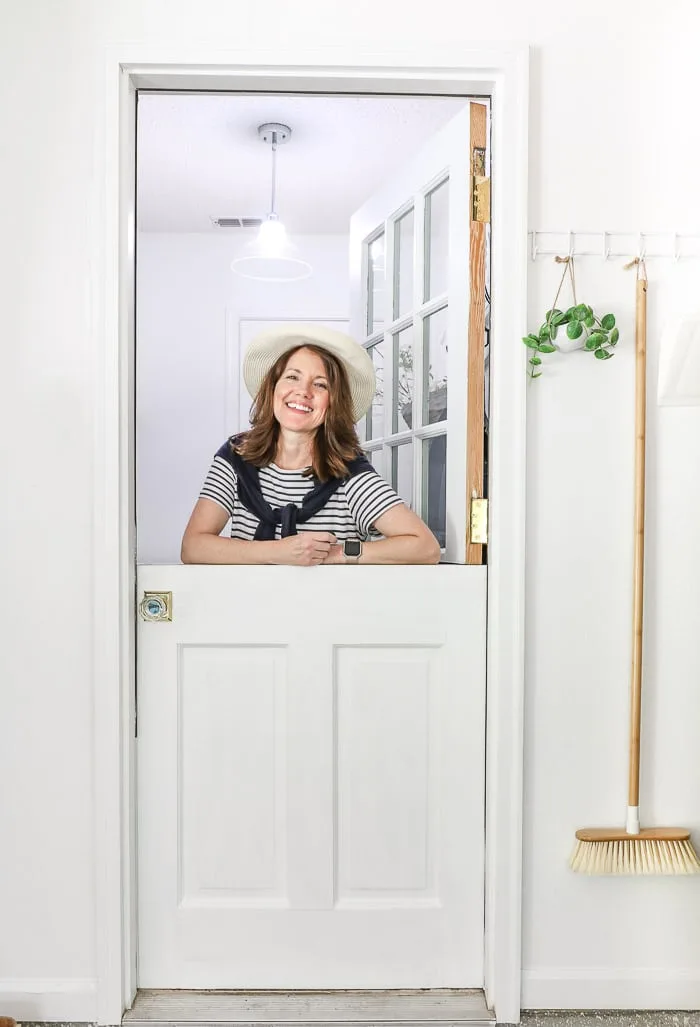 Small laundry room makeover using an old door made into a dutch door.