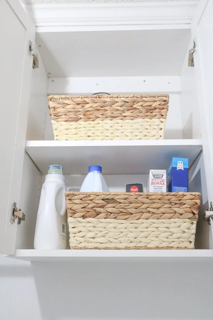 Small laundry room makeover using baskets to organize.