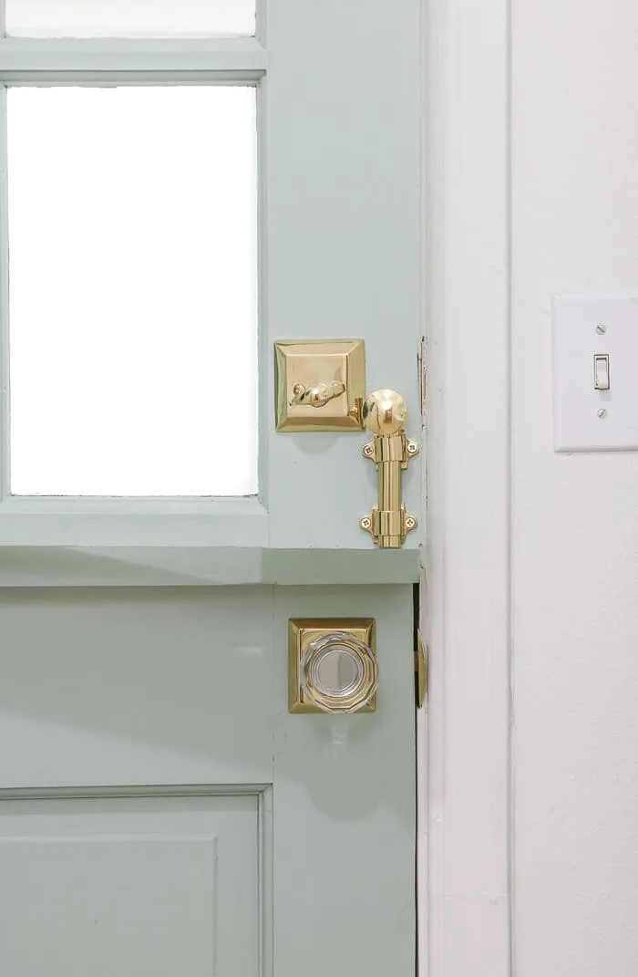 Small laundry room makeover using a dutch door and gold glass knob door hardware.