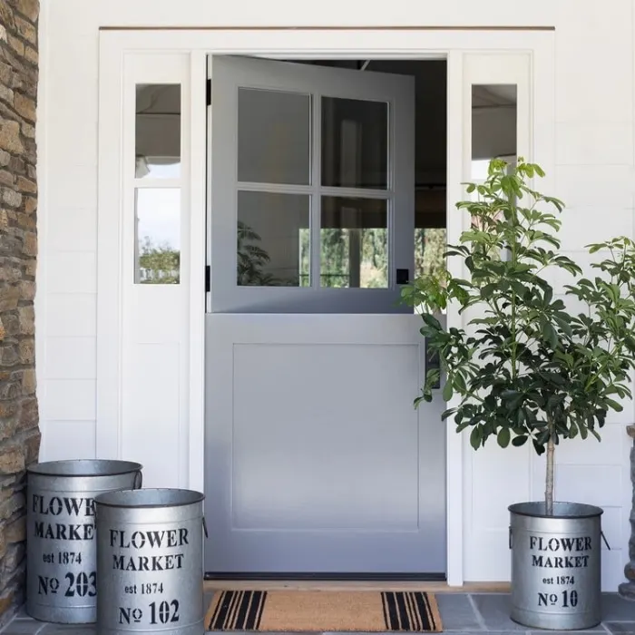 Modern Dutch Door Ideas by Studio McGee with a grey front door and flower market planters