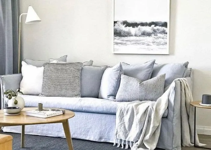 Slipcovered Sofa Ideas by The Hired Home with a light blue slipcovered sofa by Globe West