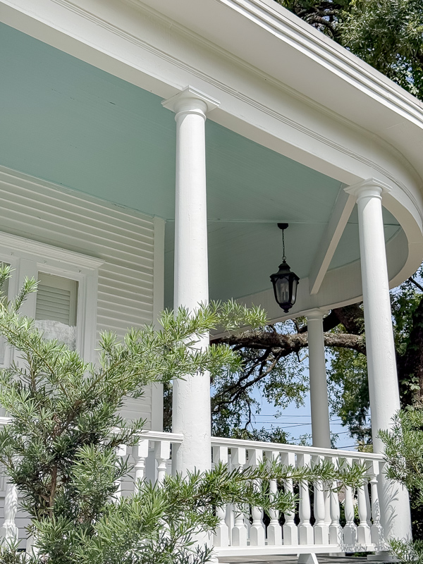 White house with columns with haint blue porch ceiling