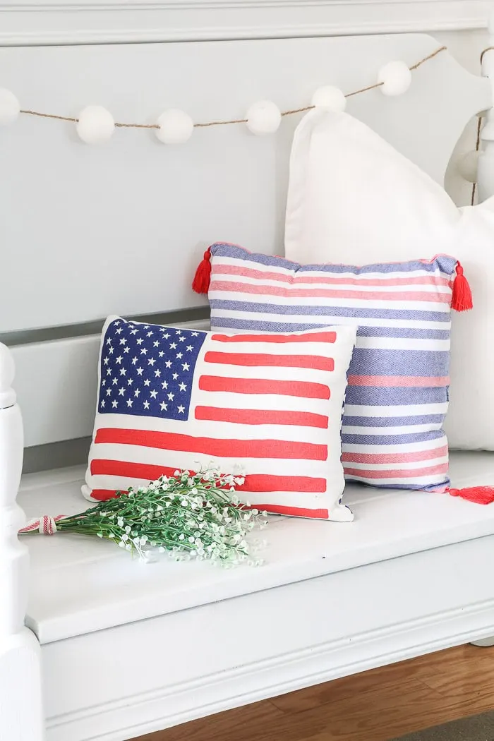 red, white and blue decorations in the entryway with American flag pillow
